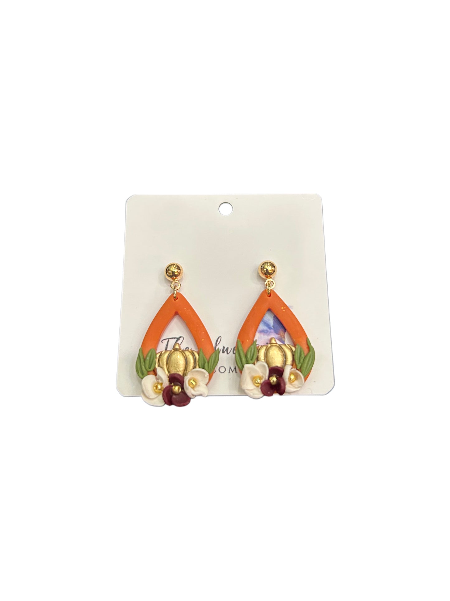 Autumn-inspired handmade clay earrings with pumpkin, petals, and gold accents.