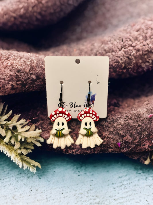 Handmade sparkly mushroom ghost earrings made from polymer clay, featuring ghosts reading a book