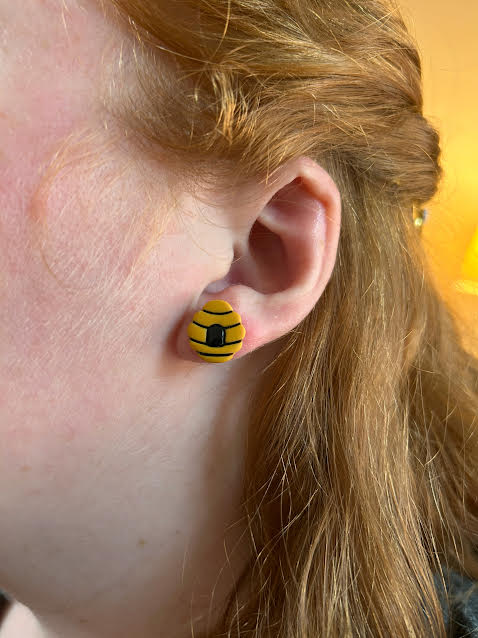 Cute bee-themed stud earrings made from polymer clay, honeycomb and beehive design, lightweight and comfortable