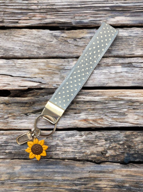 Handmade blue and white polka dot wristlet keychain with polymer clay sunflower charm