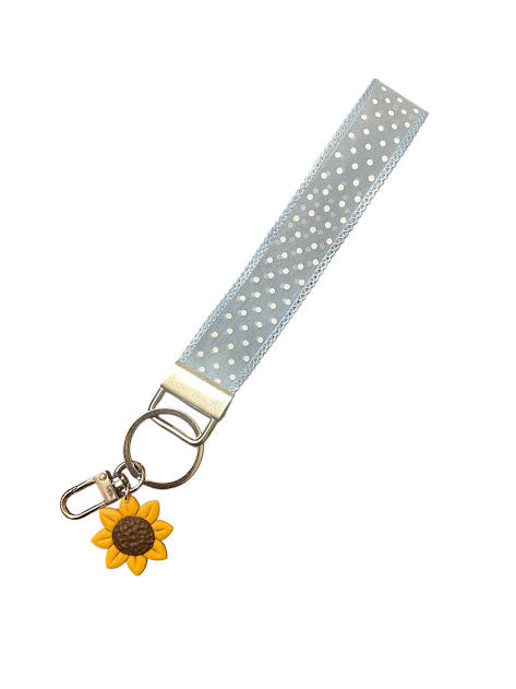 Bright sunflower charm keychain on blue polka dot wristlet ribbon