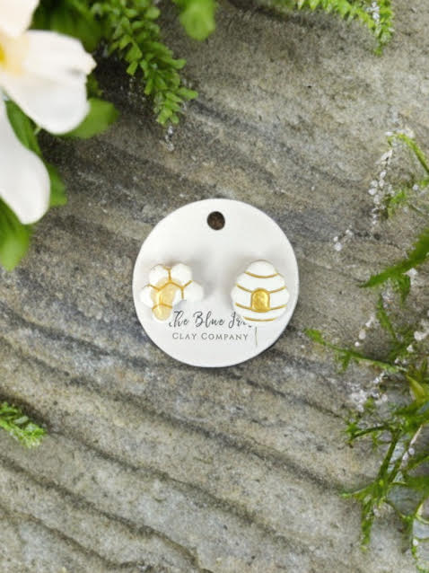 Bee-inspired polymer clay stud earrings with honeycomb and beehive details, handmade and stylish