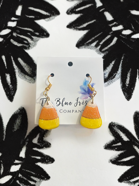 Handmade candy corn earrings crafted from polymer clay with glitter resin finish