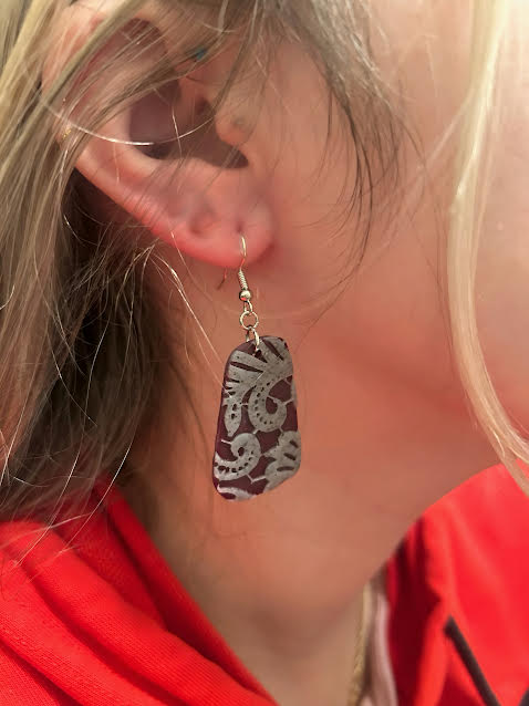 Close-up of handmade clay earrings with lace accents for special occasions
