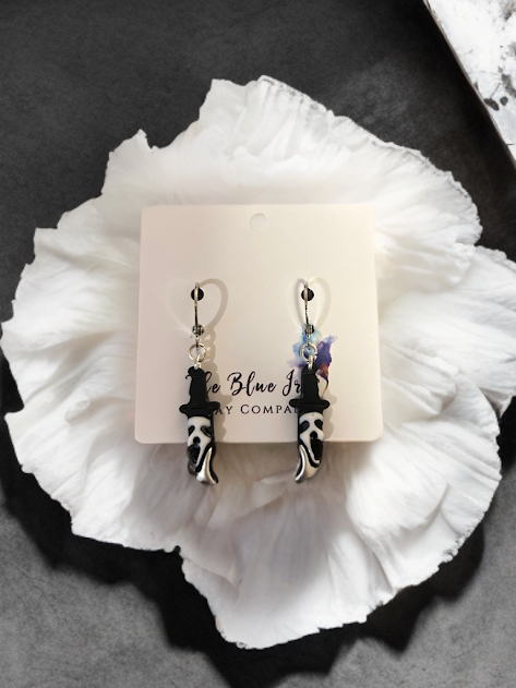 Handmade polymer clay knife earrings with scary face design