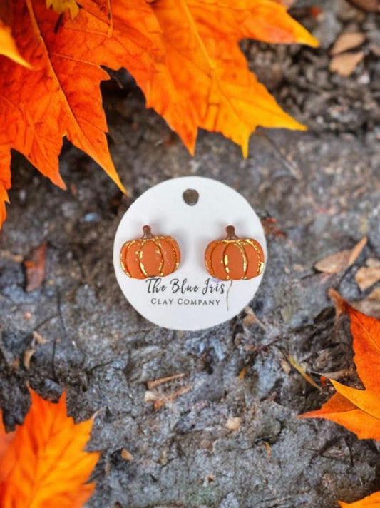 Whimsical pumpkin stud earrings made from polymer clay with gold leaf details, lightweight and nickel-free