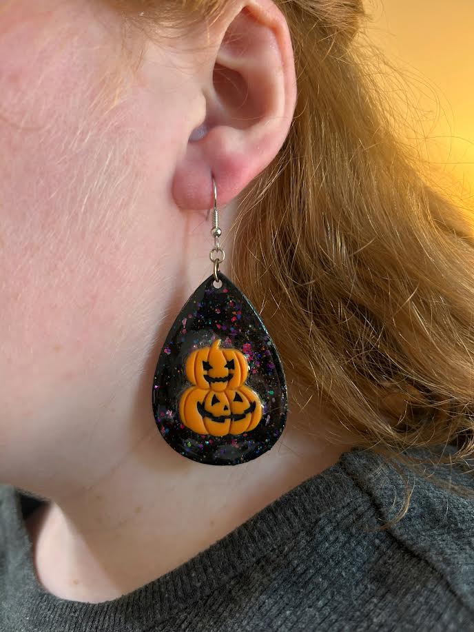 Handmade Halloween teardrop earrings with jack-o’-lantern design