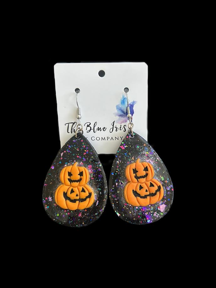 Resin and polymer clay pumpkin earrings with glitter background
