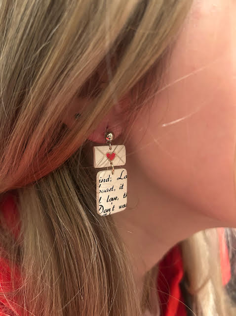Close-up of love letter earrings in polymer clay with heart detail