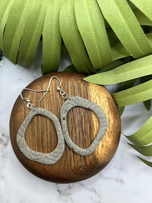 Handmade polymer clay dangle earrings with open geometric shape