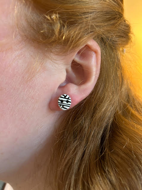 Close-up of handmade mummy stud earrings, polymer clay jewelry for sensitive ears