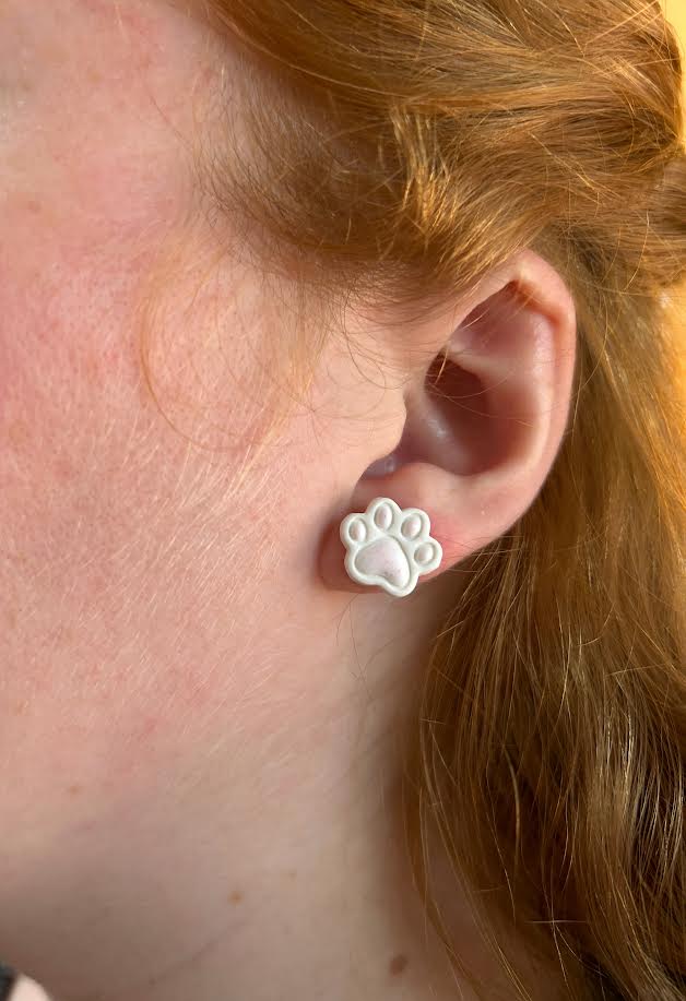 Close-up of paw print earrings, lightweight and comfortable polymer clay studs
