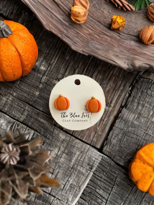 Handmade pumpkin stud earrings made from polymer clay