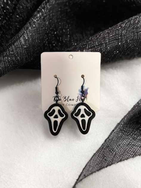 Handmade scary mask earrings crafted from polymer clay